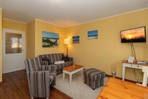 TV a/nebo společenská místnost v ubytování Urlaubstraeume-am-Meer-Wohnung-5-7-9590