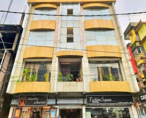 Un edificio alto con muchas ventanas y plantas. en Iris Boutique Hotel, en Jaigaon