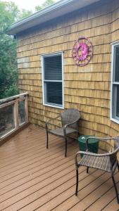 a deck with two chairs and a table and a wreath at Rehoboth Beach Haven in Rehoboth Beach