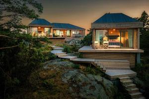 een huis op een heuvel met een trap daarheen bij Architectural Gem Between Risør And Kragerø in Søndeled