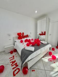 a bedroom with a large bed with red balloons on the floor at Dolci Momenti in Gragnano