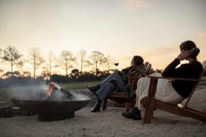 a group of people sitting around a fire pit at Box Hill Esperance in Esperance