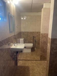a bathroom with a sink and a toilet at Dormyy backpackers castle in Guwahati