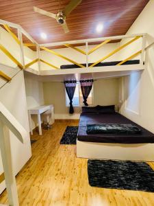 a bedroom with a bunk bed and a desk at Dormyy backpackers castle in Guwahati