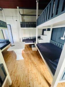 a room with a bunk bed and a white table at Dormyy backpackers castle in Guwahati