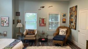a bedroom with a bed and a chair and a table at Rehoboth Beach Haven in Rehoboth Beach