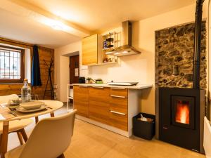 eine Küche mit einem Tisch und einem Kamin in der Unterkunft ALP BREAK 2 - Nel Borgo Storico del Ponte Romano in Aosta