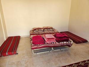 a bed sitting in a corner of a room at Rum Adventures Hostel in Wadi Rum