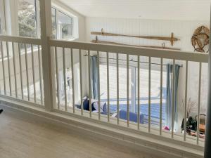 a room with a balcony with windows and a pool at Hyggeligt Familiehus Omgivet Af Ø-Landskab in Fitjar
