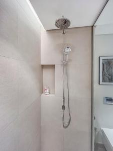 a shower with a shower head in a bathroom at Marrasi Vista by the address in Muharraq