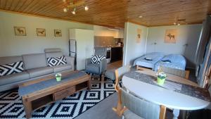a living room with a couch and a table at Abrahams Camp in Flisehult