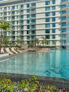 a large apartment building with a large swimming pool at Marrasi Vista by the address in Muharraq