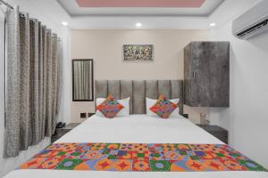 a bedroom with a large bed in a room at FabHotel Yatri Nivas - Assi Ghat in Varanasi