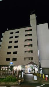 a large building at night with a lit up at UrbanHotelTokyoShinmatsudo in Matsudo