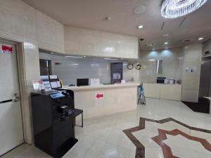 a lobby with a cash counter in a building at UrbanHotelTokyoShinmatsudo in Matsudo
