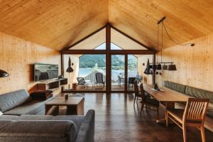 a living room with a couch and a table at Regitnig - 4 Sterne Hotel und Chalets in Weissensee