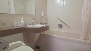 a bathroom with a sink and a toilet and a tub at UrbanHotelTokyoShinmatsudo in Matsudo +9 photos