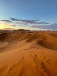 an aerial view of the desert at sunset at Family Berber Camp in Merzouga +13 photos