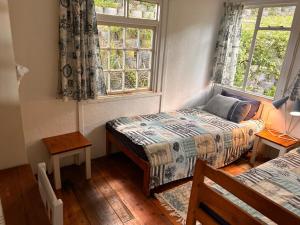 a bedroom with two beds and a window at Explore River Cottage Ocean View in Seafield