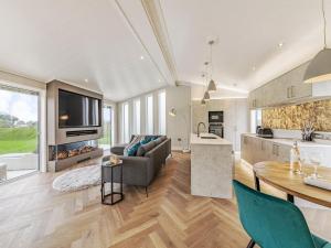 a kitchen and living room with a table and a couch at Landal North Lakes in Brayton Station