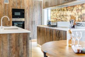 a kitchen with wooden cabinets and a wooden table at Landal North Lakes in Brayton Station