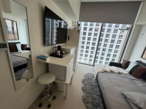 a bedroom with a bed and a desk and a mirror at Only female ladies only Private room shared bathroom of a residential tower vs pool view & downtown view & pv rooftop parking minimum staying of 5 nights in Dubai
