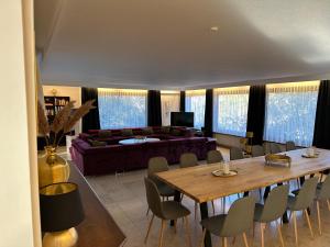 a living room with a table and a couch at Haus Anna in Alpirsbach +12 photos