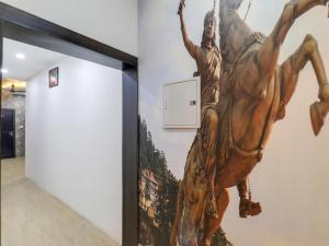 a large painting of a woman on a horse on a wall at Super Hotel O Centrum in Gorakhpur +24 photos