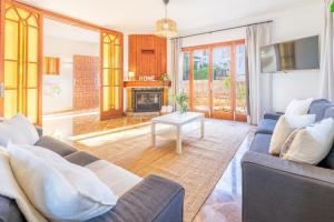 a living room with two blue couches and a fireplace at Villa Ribera de Son Veri in El Arenal +32 photos