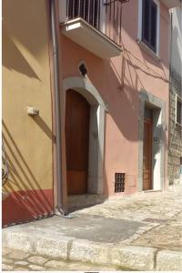 a building with two doors and a balcony at VicoloHOME in Fragneto lʼAbate