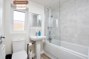 a bathroom with a toilet and a sink and a shower at Spacious, 3BR, Coventry House | Sleeps 9 | Parking in Canley +24 photos