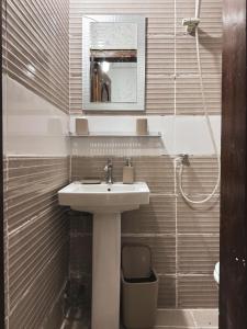 a bathroom with a sink and a mirror at Aiah Cocoon in Abidjan +44 photos