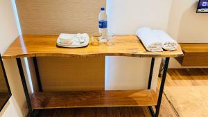a table with a bottle of water and glasses on it at Hotel COCODAN in Indore