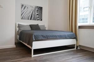 Postel nebo postele na pokoji v ubytování Moderne City Apartments im Stadtzentrum