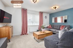 a living room with a couch and a tv at Spacious, 3BR, Coventry House | Sleeps 9 | Parking in Canley