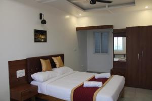 Ένα ή περισσότερα κρεβάτια σε δωμάτιο στο DJ Palace and Residency