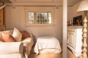a living room with a couch and a window at La Limonaia - Tremezzo by LoveComo in Tremezzo