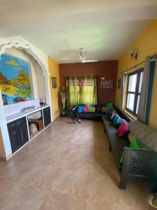 a living room with a couch and a fireplace at Krishna Divine 2 Bedroom Home in mayapur