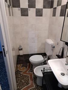 a bathroom with a toilet and a sink at BB Sextum in Genoa