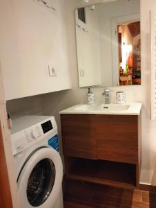a bathroom with a washing machine and a sink at Erbanova in Sila in Camigliatello Silano