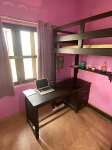 a bedroom with a desk and bunk bed with a laptop at Krishna Divine 2 Bedroom Home in mayapur