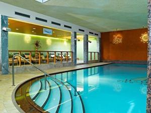 a large swimming pool in a hotel room at Schusslerhof in Sankt Leonhard im Pitztal