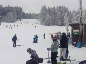 a group of people on skis on a ski slope at Family apartment Vysočina SKI plus BIATLON in Nové Město na Moravě