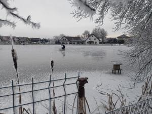a person is standing in the middle of a body of water at Family apartment Vysočina SKI plus BIATLON in Nové Město na Moravě