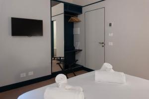 a room with a bed with two towels on it at Dal Console Rooms in Naples