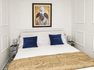 a bedroom with a bed with a painting on the wall at Casa Del Duca in Salerno