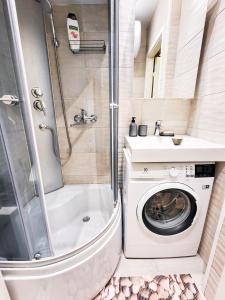 a bathroom with a washing machine and a sink at Furnished apartment with a very good location in Kristiine in Tallinn