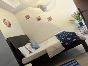 a bedroom with a bed with pillows and a chandelier at Kampala suites Kisementi in Kampala