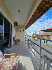 a balcony of a house with a view of the city at Casa ampla e confortável em Balneário Camboriú in Balneário Camboriú