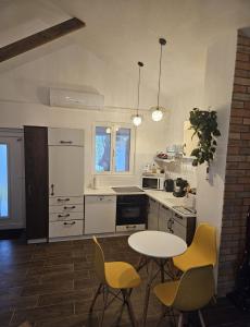 a kitchen with a table and two chairs and a table at Marina Cottage in Enying